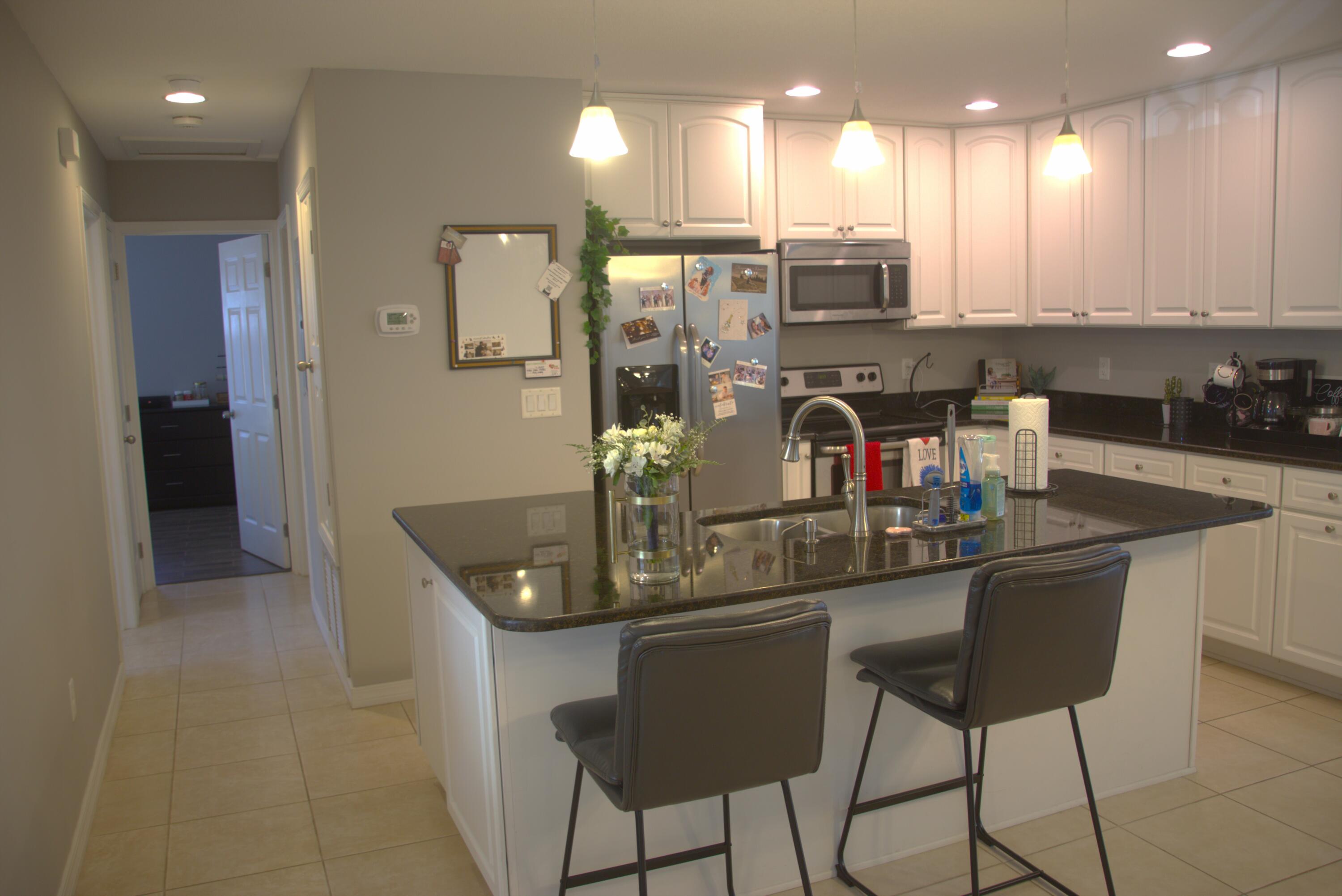 75 7th Avenue Shalimar, FL 32579 - Photo 4 of 42 a kitchen with stainless steel appliances granite countertop a sink and a refrigerator