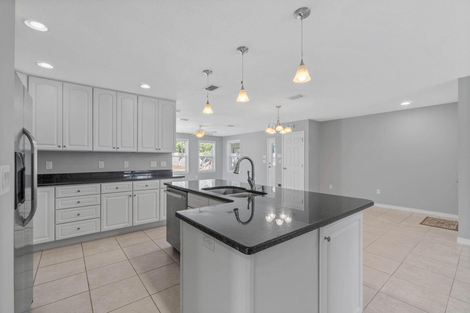 75 7th Avenue Shalimar, FL 32579 - Photo 5 of 42 a kitchen with a sink window and cabinets