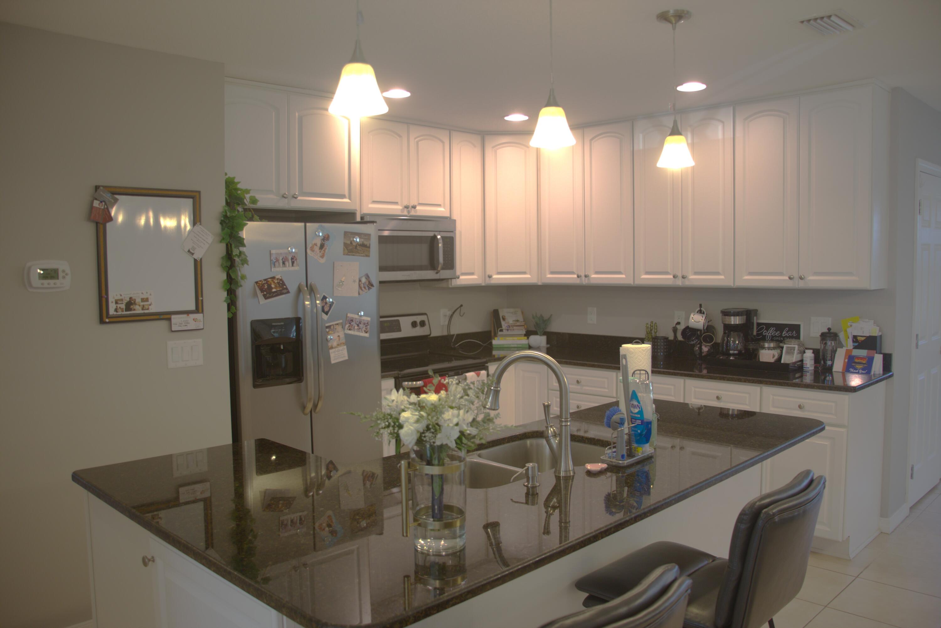 75 7th Avenue Shalimar, FL 32579 - Photo 6 of 42 a kitchen with a sink a counter top space cabinets and stainless steel appliances