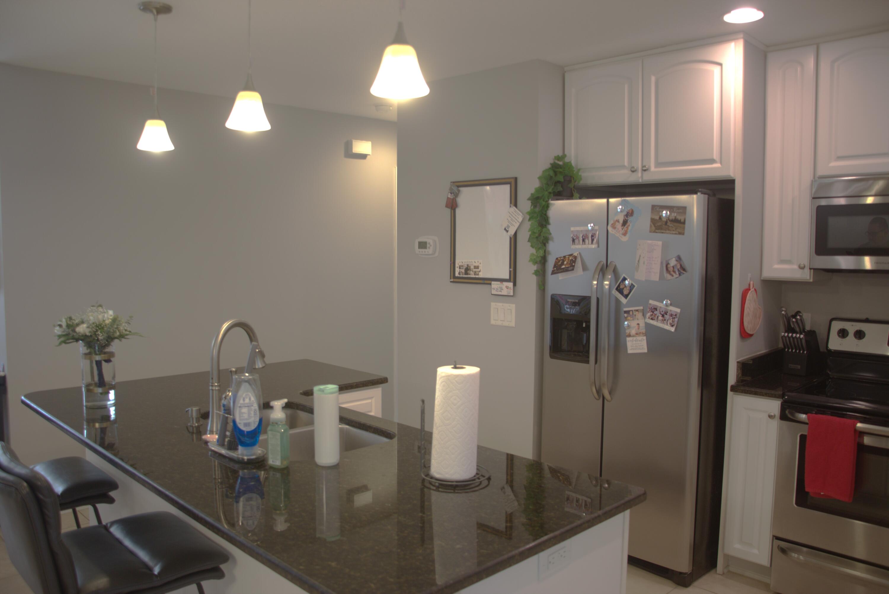 75 7th Avenue Shalimar, FL 32579 - Photo 7 of 42 a kitchen with refrigerator and car