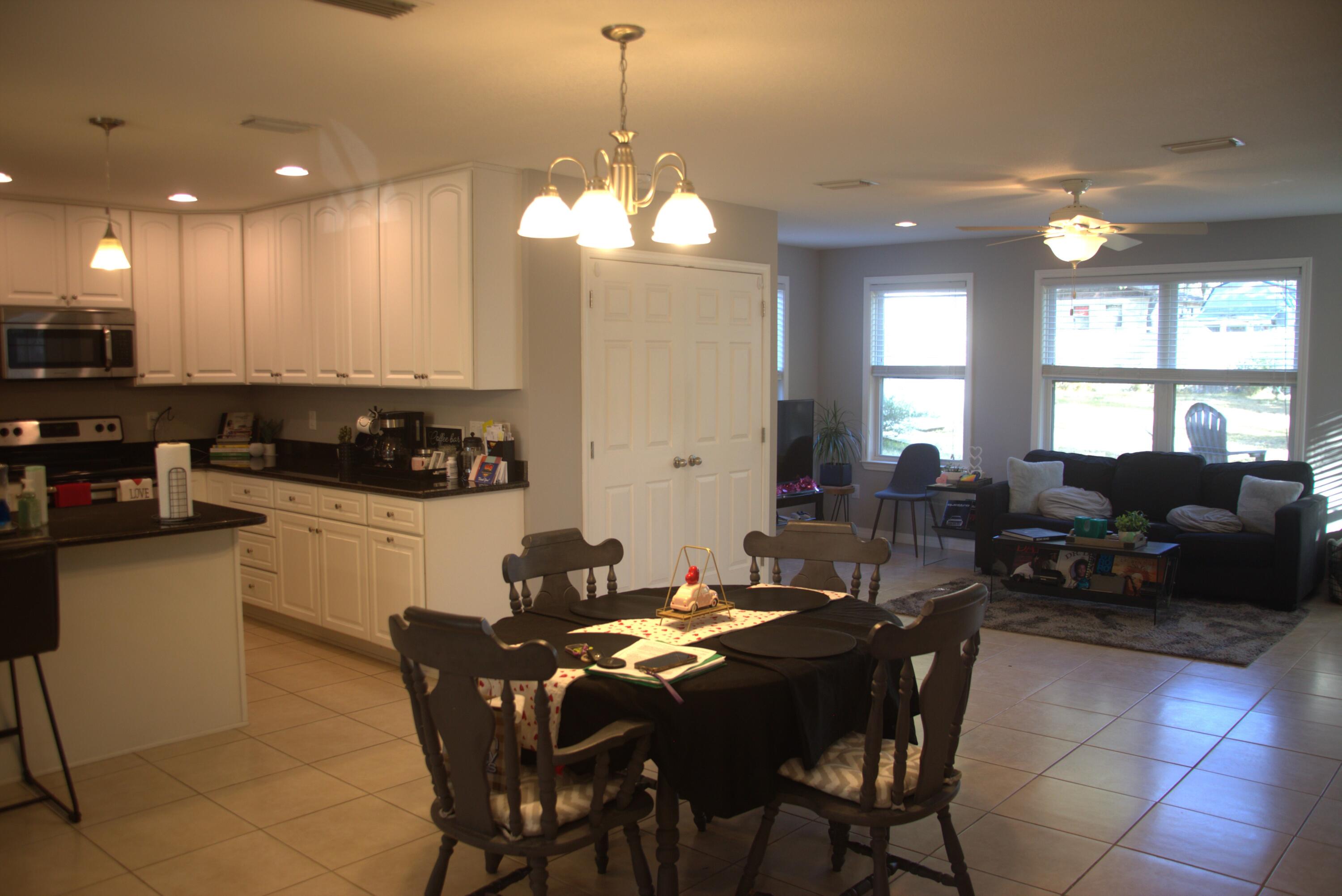 75 7th Avenue Shalimar, FL 32579 - Photo 8 of 42 a view of a dining room with furniture and chandelier