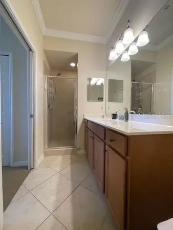 a bathroom with a sink mirror and shower