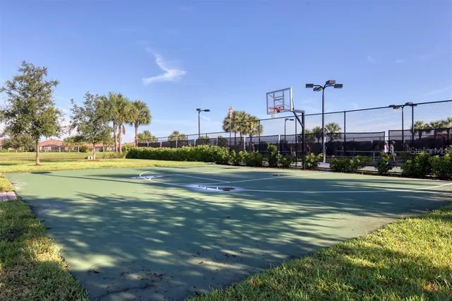 a view of a swimming pool with a yard and plants