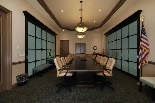 a view of a dining room with furniture a chandelier and wooden floor