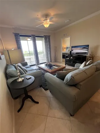 a living room with furniture and a chandelier