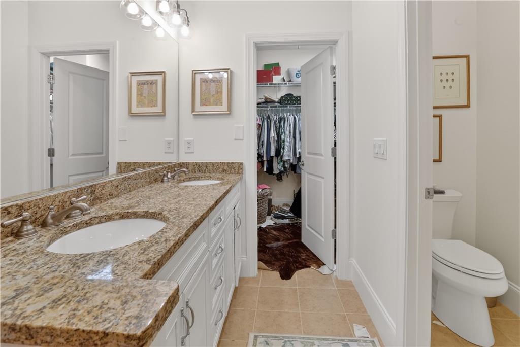 3552 Roswell Road Northwest Atlanta, GA 30305 - Photo 17 of 32 a en suite bathroom with a granite countertop sink and a mirror