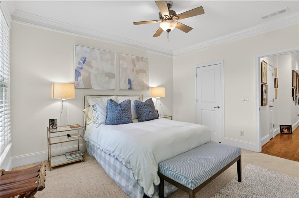 3552 Roswell Road Northwest Atlanta, GA 30305 - Photo 24 of 32 a bedroom with a bed and a chandelier