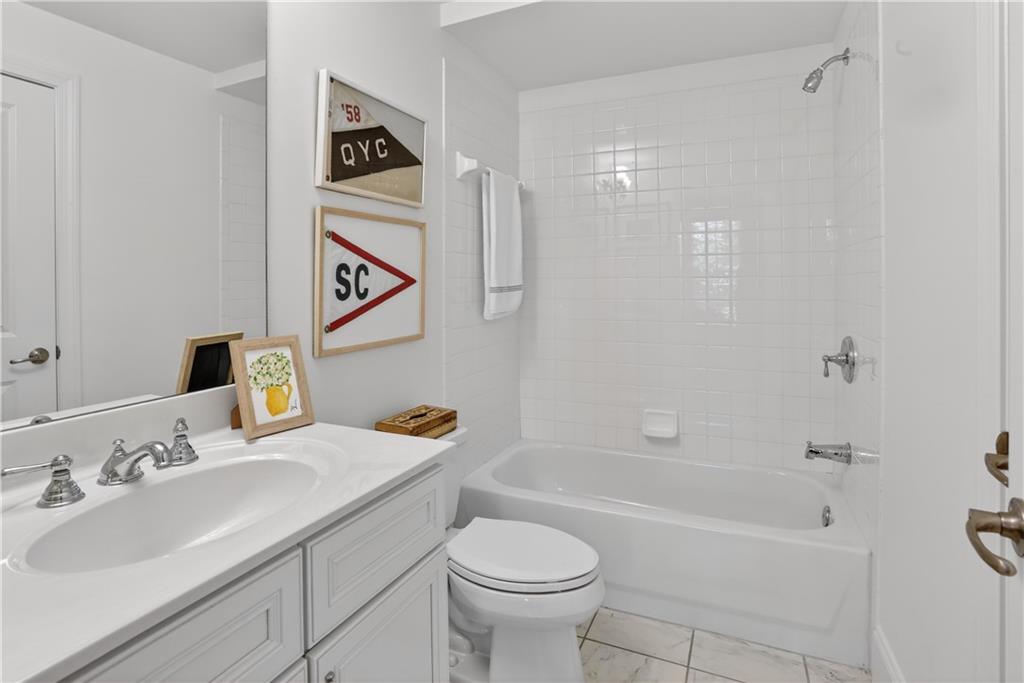 3552 Roswell Road Northwest Atlanta, GA 30305 - Photo 28 of 32 a bathroom with a sink toilet and a bathtub