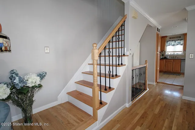 a view of entryway and hall with wooden floor