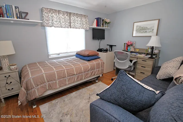 a bedroom with two beds and a couch