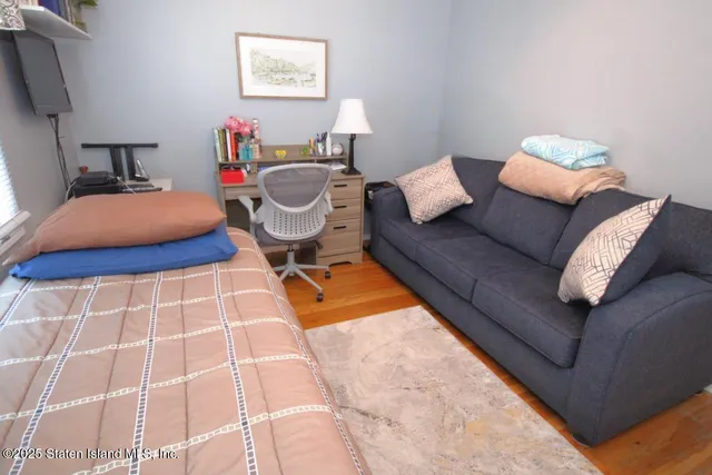 a living room with furniture and a lamp