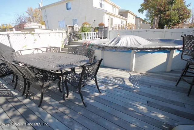 a outdoor dining space with furniture and wooden floor