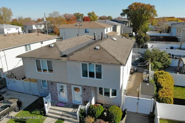 an aerial view of a house with a garden and plants
