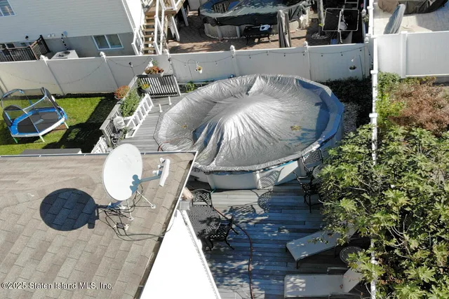 an aerial view of a house with swimming pool and sitting area
