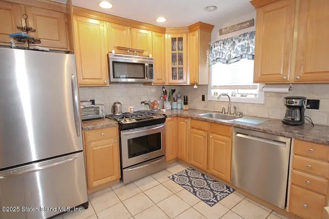 a kitchen with a refrigerator sink and microwave