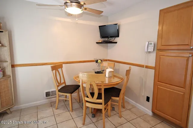 a dining room with furniture and a flat screen tv