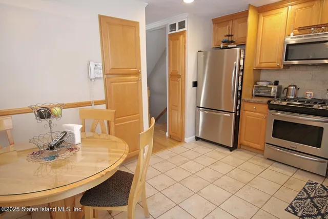 a kitchen with stainless steel appliances a refrigerator and a sink