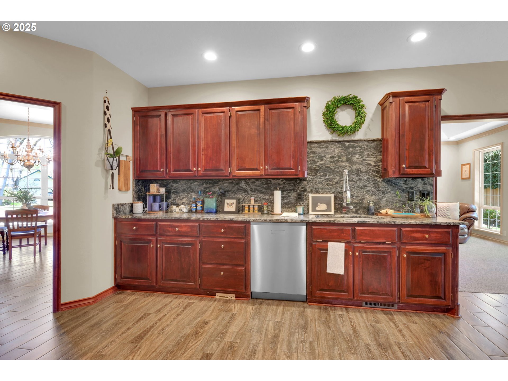 1417 Wimbledon Place Springfield, OR 97477 - Photo 18 of 48 a kitchen with wooden floors and wooden cabinets