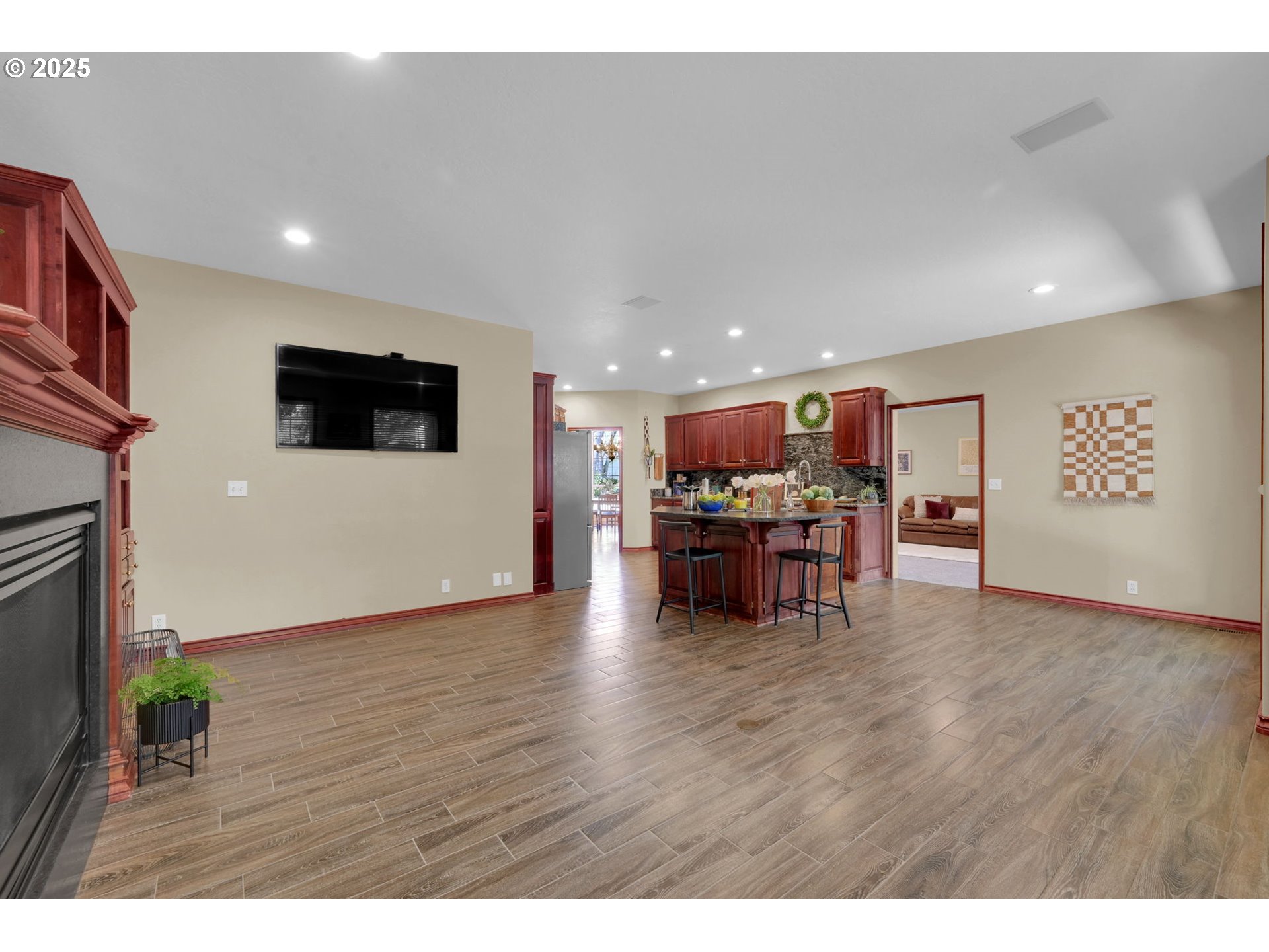 1417 Wimbledon Place Springfield, OR 97477 - Photo 24 of 48 a view of an empty room with wooden floor and a kitchen