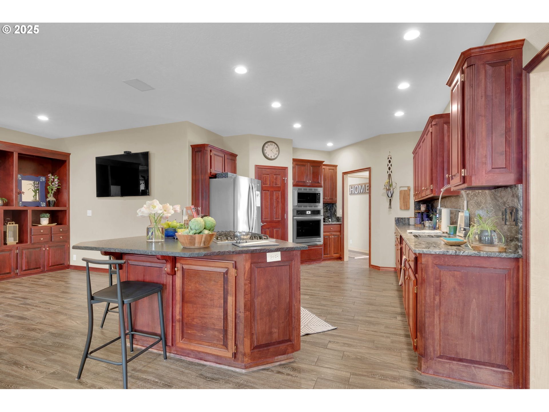1417 Wimbledon Place Springfield, OR 97477 - Photo 25 of 48 a living room with stainless steel appliances kitchen island granite countertop furniture and a flat screen tv