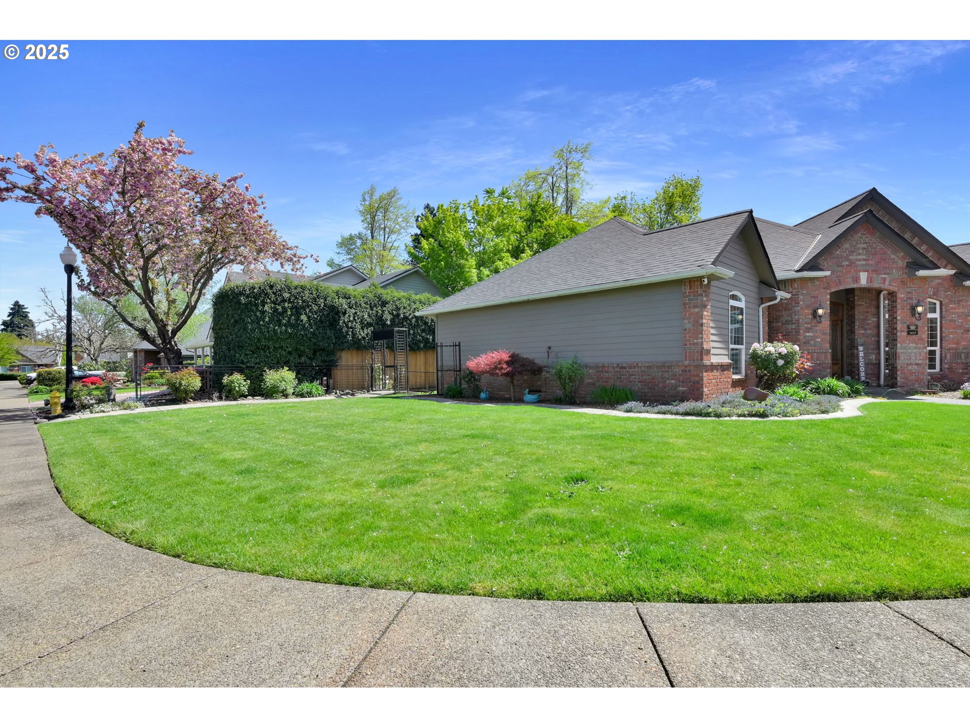 1417 Wimbledon Place Springfield, OR 97477 - Photo 3 of 48 a front view of a house with a garden and yard