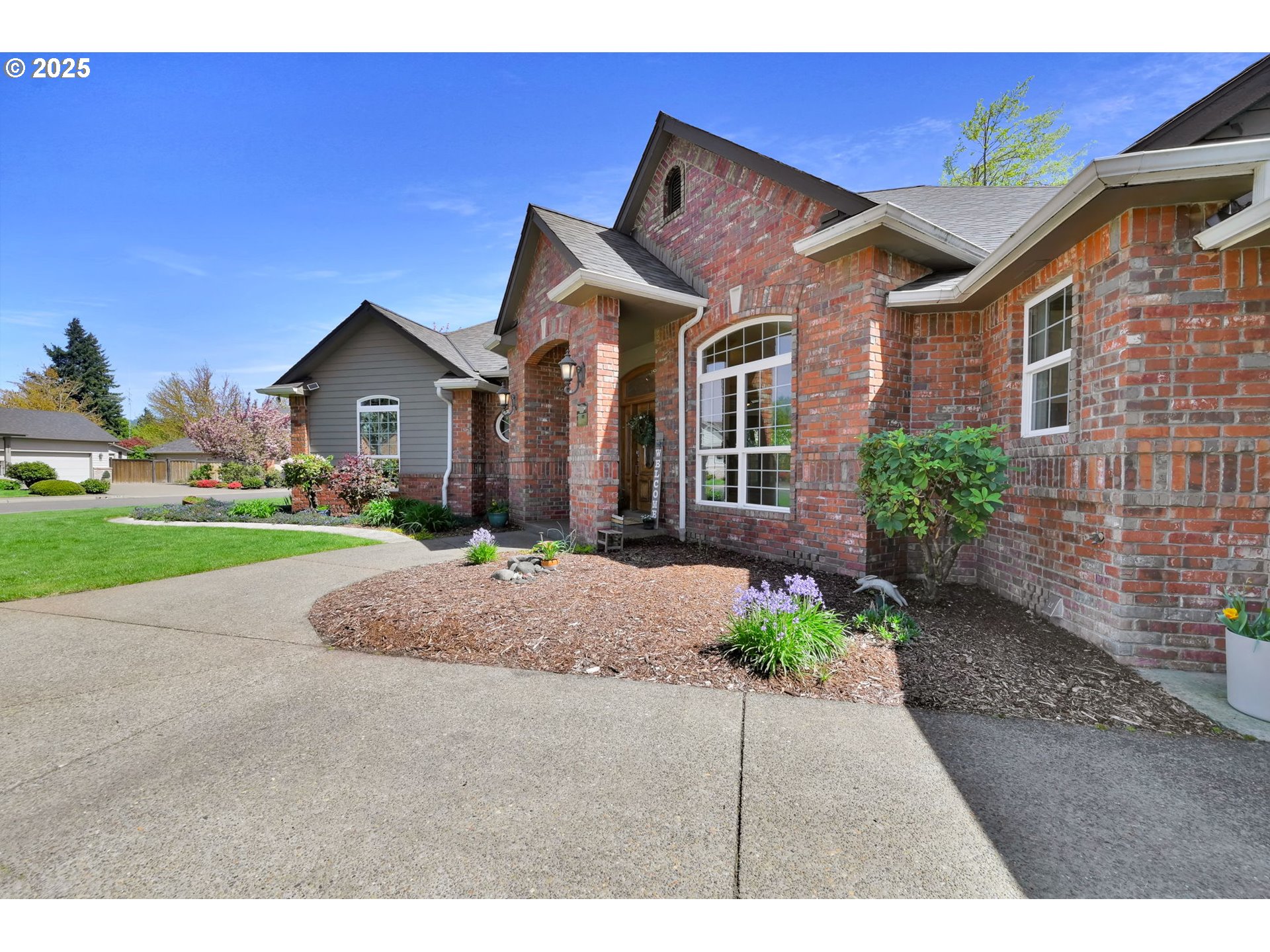 1417 Wimbledon Place Springfield, OR 97477 - Photo 5 of 48 a front view of a house with a yard and potted plants