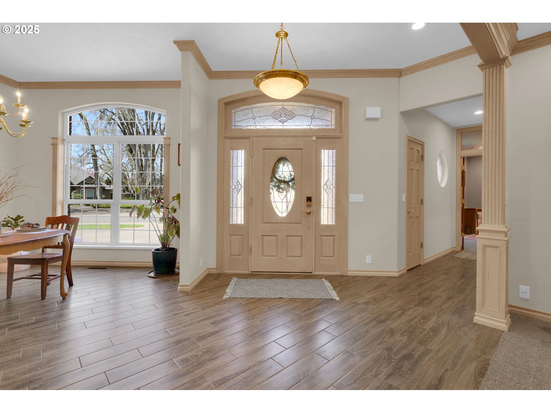 1417 Wimbledon Place Springfield, OR 97477 - Photo 10 of 48 a view of a livingroom with furniture wooden floor a chandelier and a flat screen tv