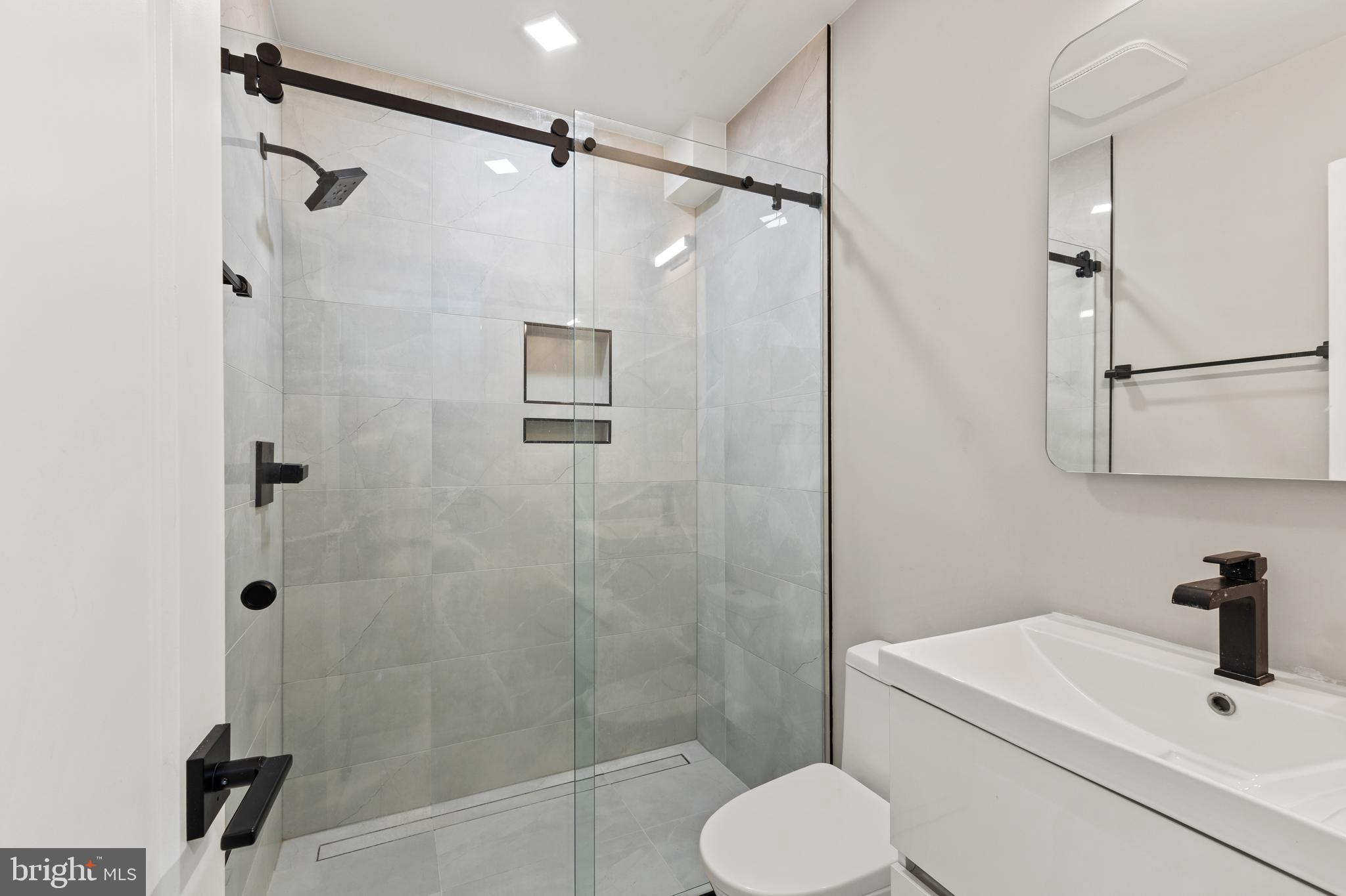 1028 Bladensburg Road Northeast, Unit 37 Washington, DC 20002 - Photo 11 of 29 a bathroom with a shower toilet and sink