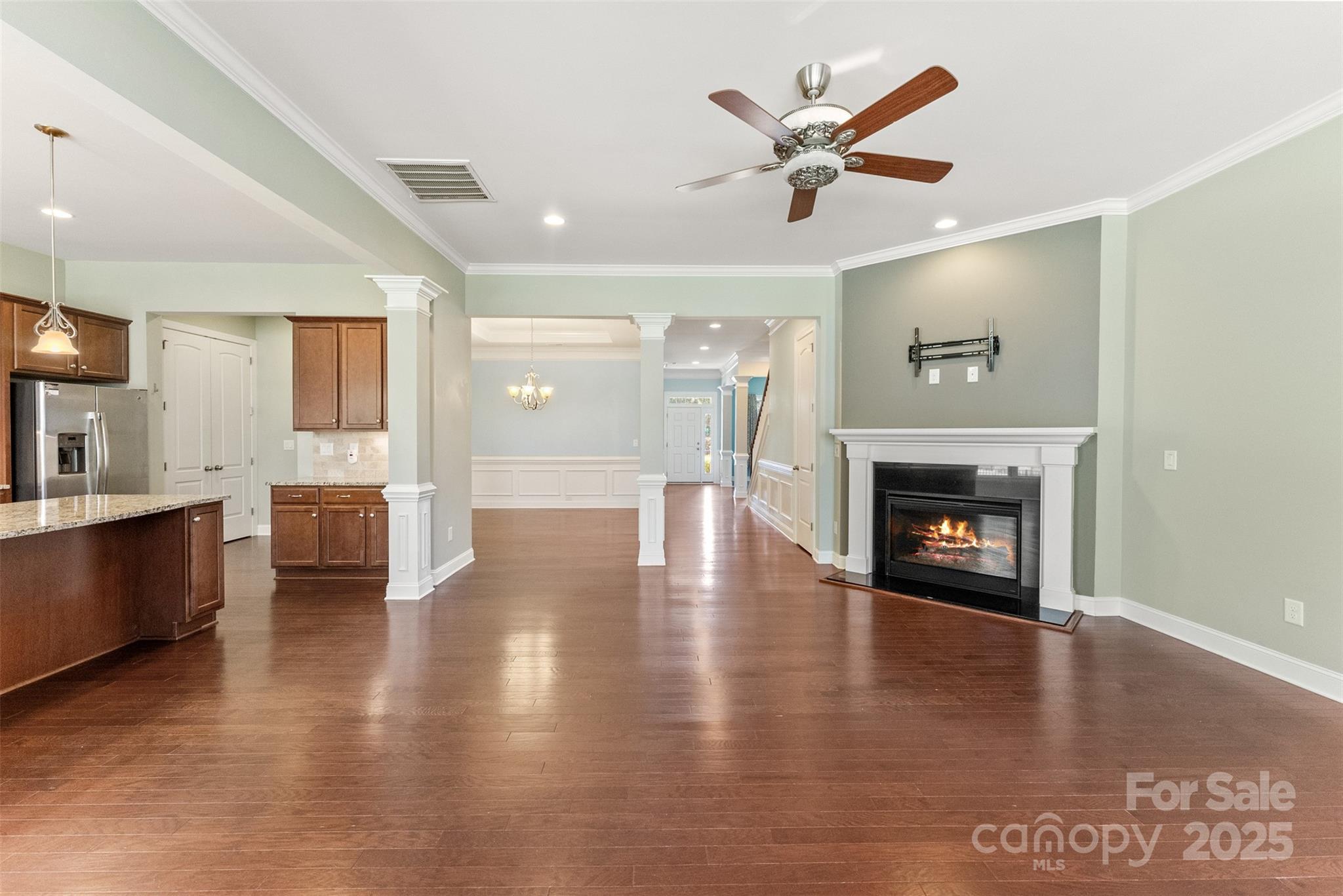 a view of an empty room with a fireplace and a window