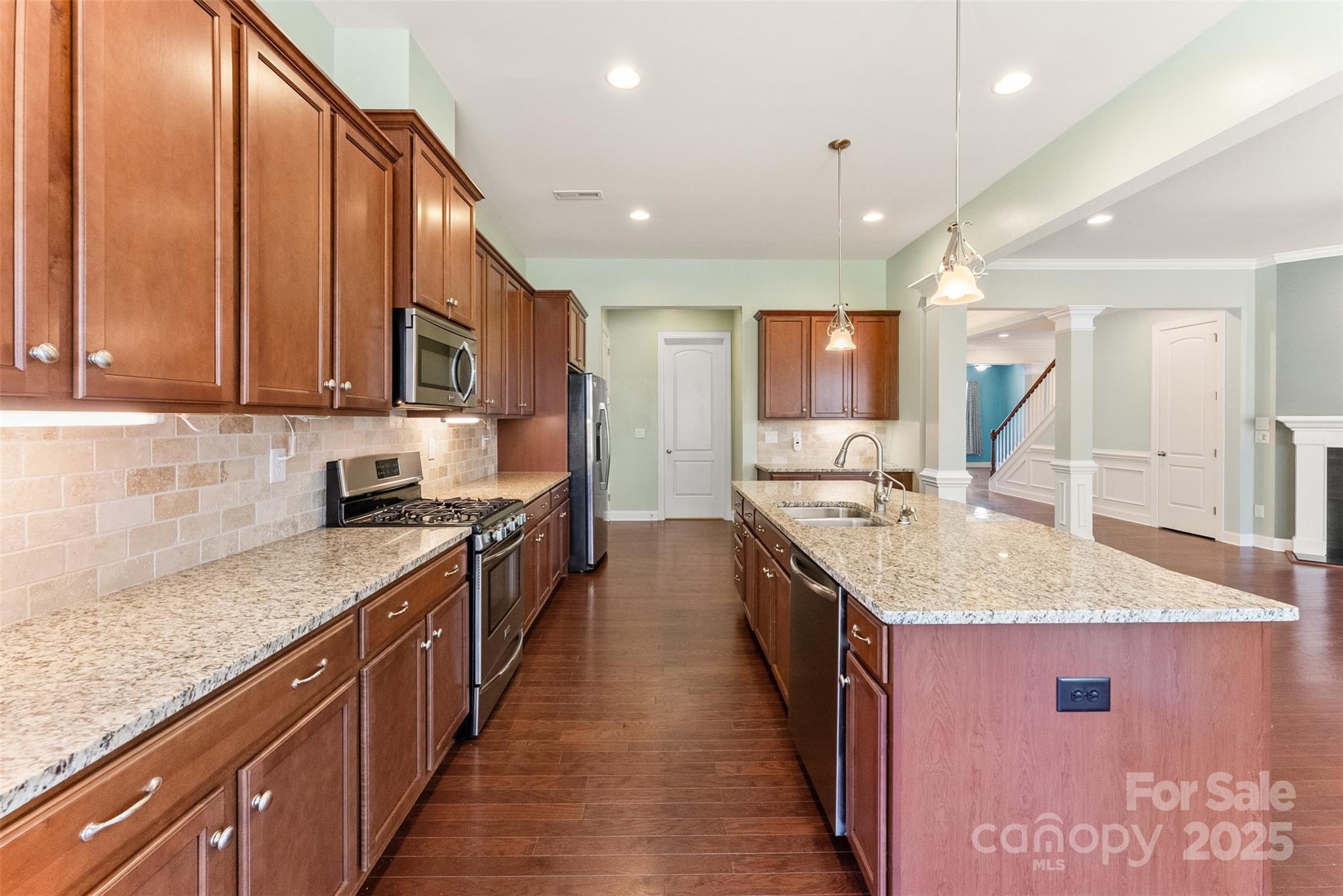11037 Thornbeck Lane Midland, NC 28107 - Photo 20 of 46 a kitchen with stainless steel appliances granite countertop a sink stove and cabinets