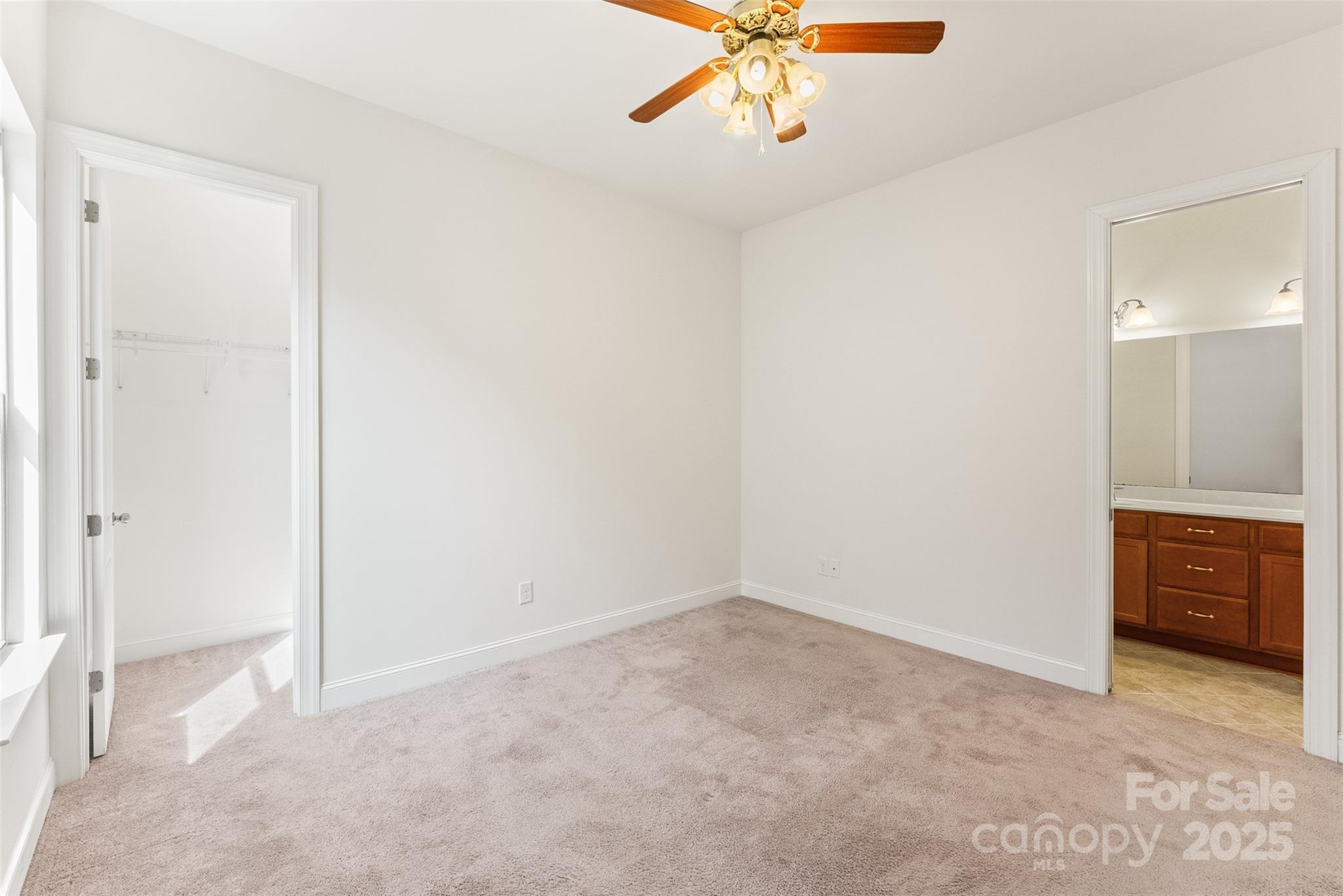 11037 Thornbeck Lane Midland, NC 28107 - Photo 29 of 46 an empty room with a chandelier fan and closet