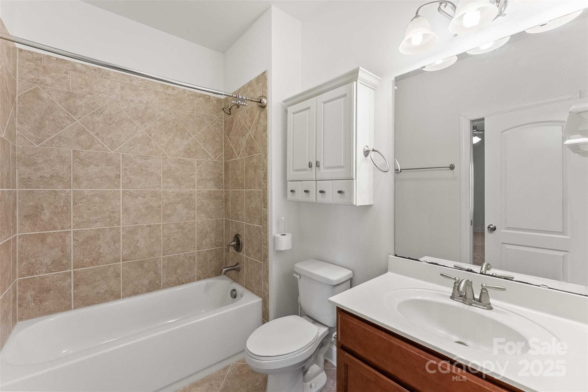 11037 Thornbeck Lane Midland, NC 28107 - Photo 35 of 46 a bathroom with a granite countertop bathtub shower sink vanity mirror and toilet