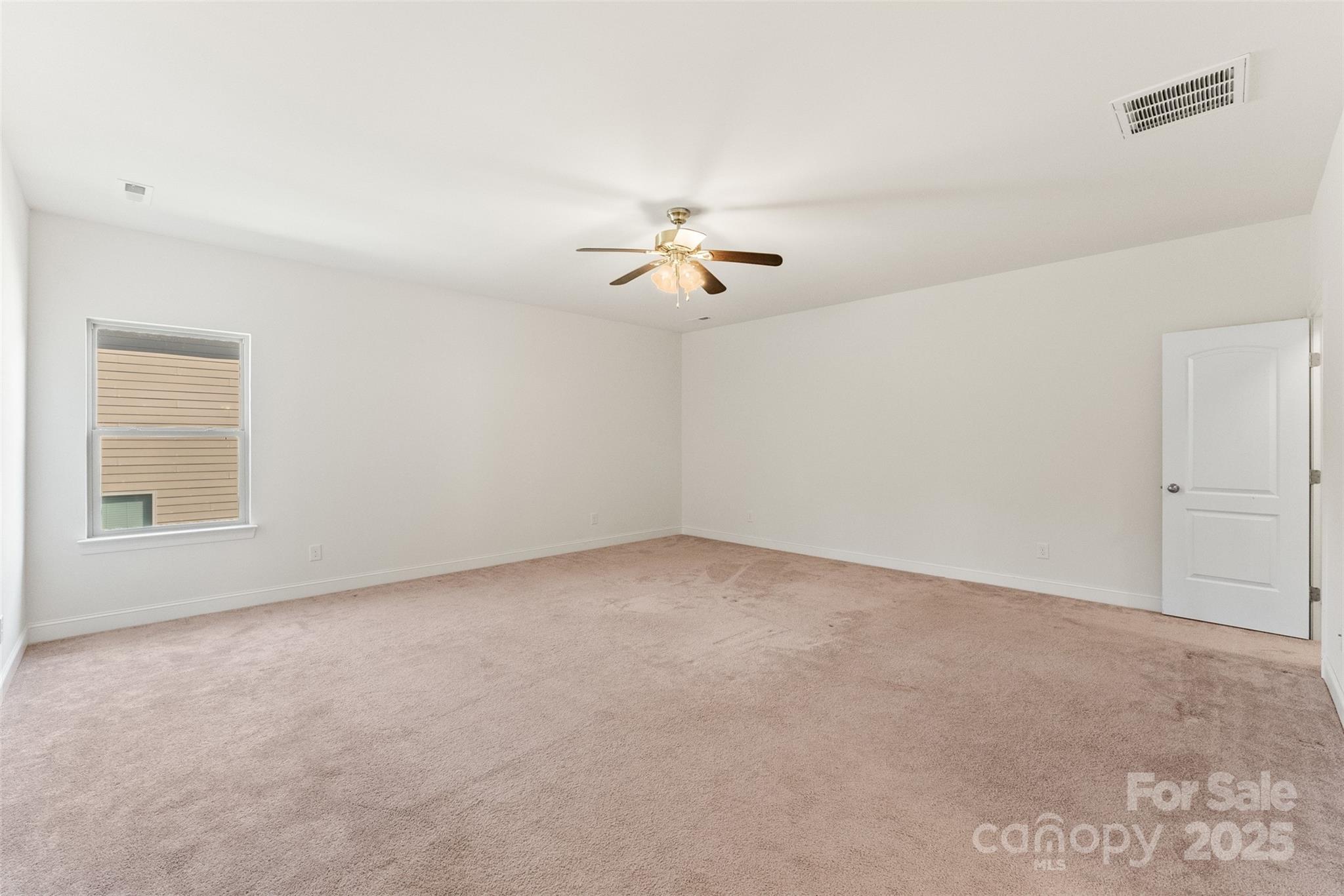 11037 Thornbeck Lane Midland, NC 28107 - Photo 36 of 46 a view of a room with a ceiling fan and a window