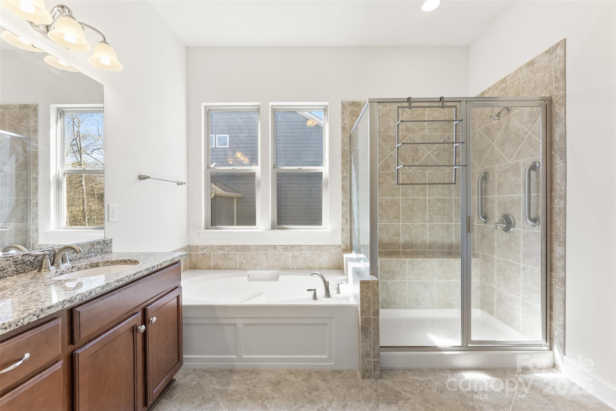 11037 Thornbeck Lane Midland, NC 28107 - Photo 8 of 46 a bathroom with a bathtub and a sink