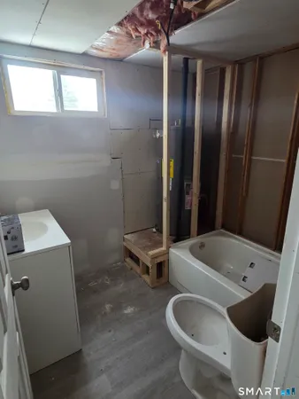 a bathroom with a tub and sink