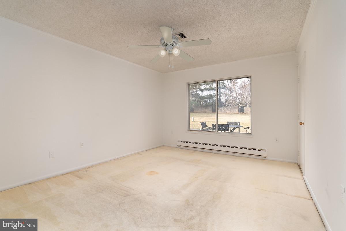 3507 Tarkington Lane, Unit 66A Silver Spring, MD 20906 - Photo 18 of 39 an empty room with windows and fan