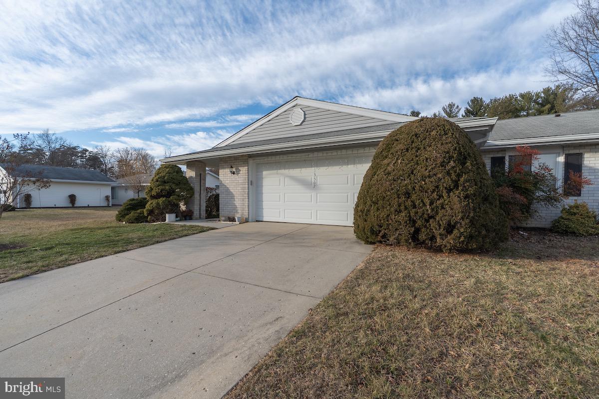 3507 Tarkington Lane, Unit 66A Silver Spring, MD 20906 - Photo 39 of 39 a view of a grey house with a yard