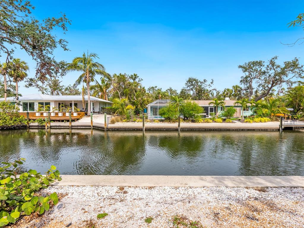 615 Buttonwood Drive Longboat Key, FL 34228 - Photo 11 of 43 a view of a lake with a house