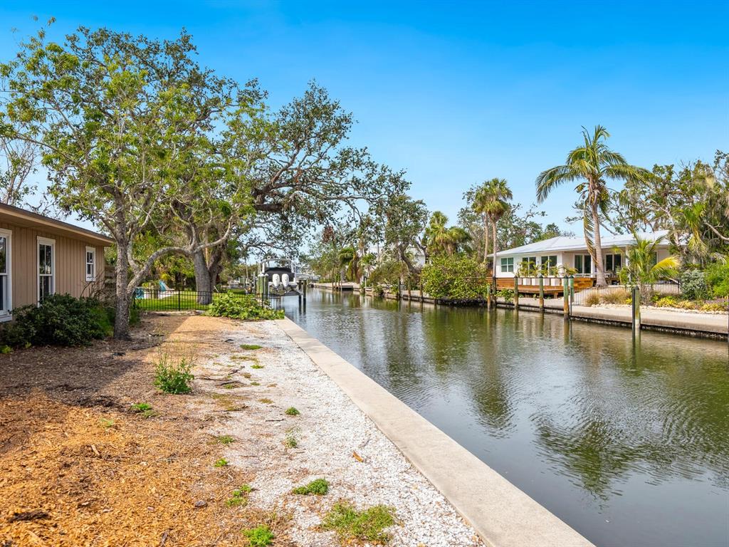 615 Buttonwood Drive Longboat Key, FL 34228 - Photo 13 of 43 a view of a lake with houses