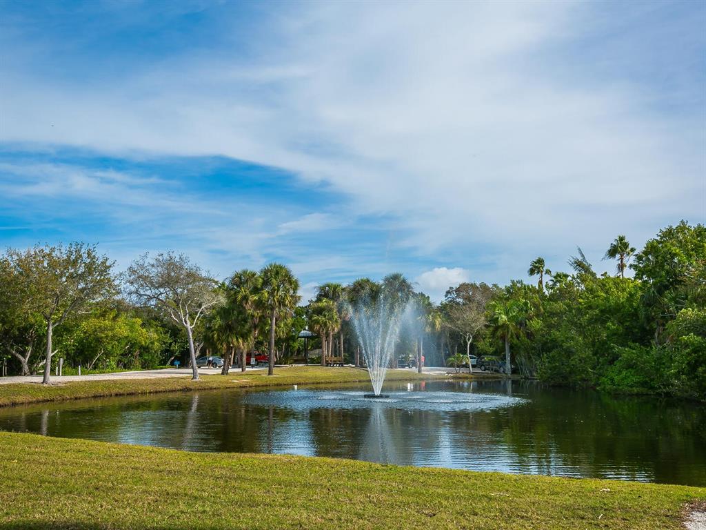 615 Buttonwood Drive Longboat Key, FL 34228 - Photo 29 of 43 a view of a lake with houses in the back