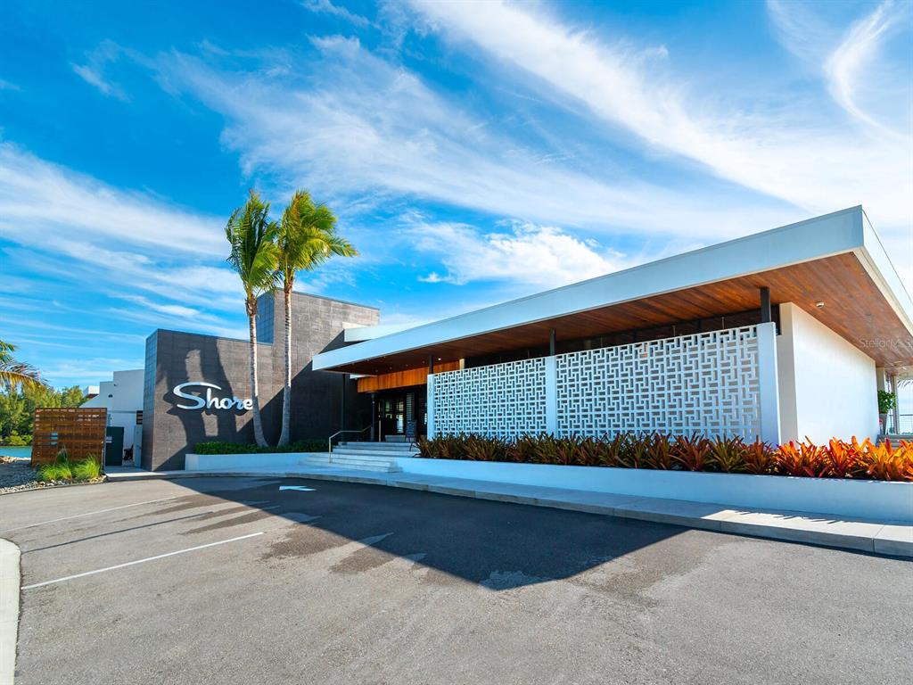 615 Buttonwood Drive Longboat Key, FL 34228 - Photo 37 of 43 a front view of a house with a yard and potted plants