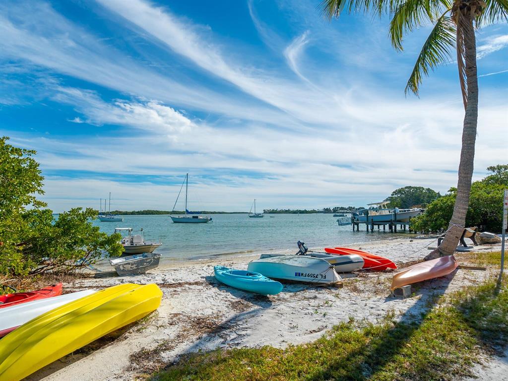 615 Buttonwood Drive Longboat Key, FL 34228 - Photo 39 of 43 a view of swimming pool with a table and chairs