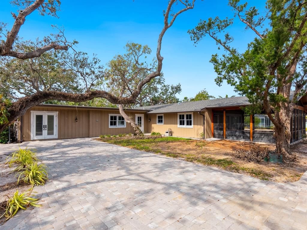 615 Buttonwood Drive Longboat Key, FL 34228 - Photo 6 of 43 a front view of a house with a garden