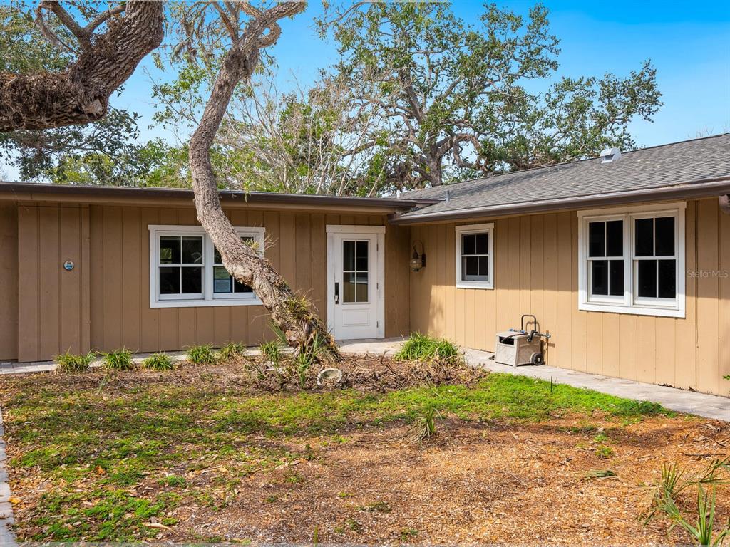 615 Buttonwood Drive Longboat Key, FL 34228 - Photo 7 of 43 a front view of a house with garden