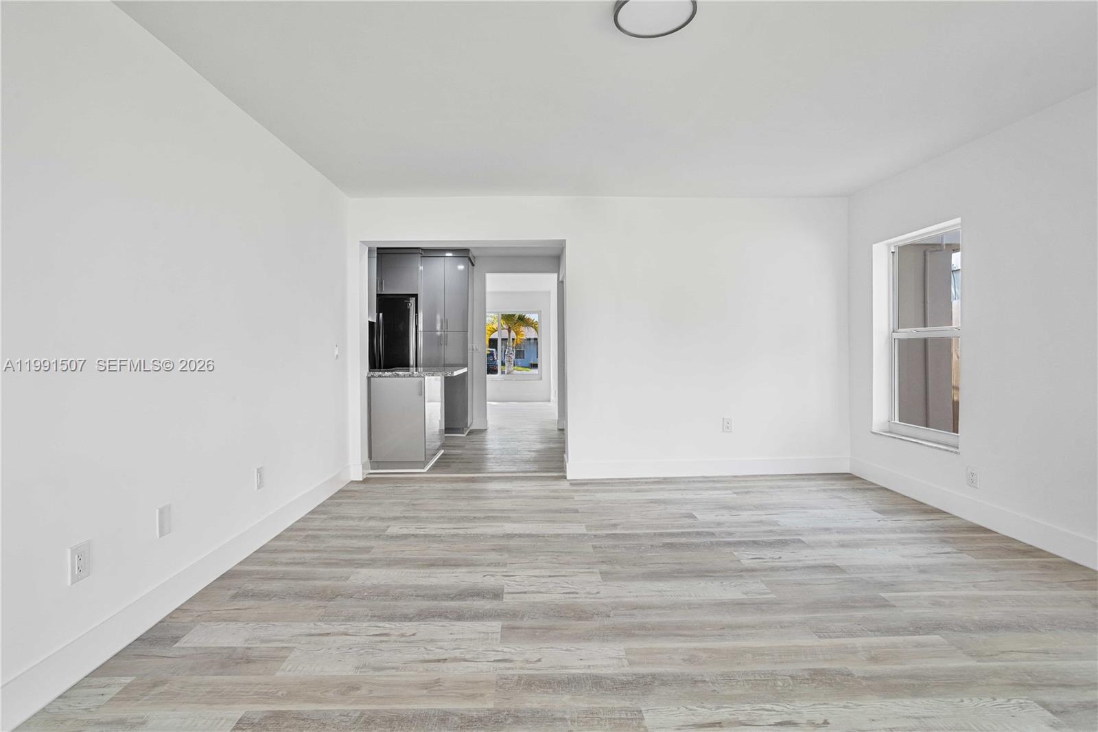4157 Southwest 49th Court Dania Beach, FL 33314 - Photo 11 of 46 a view of a big room with wooden floor and windows