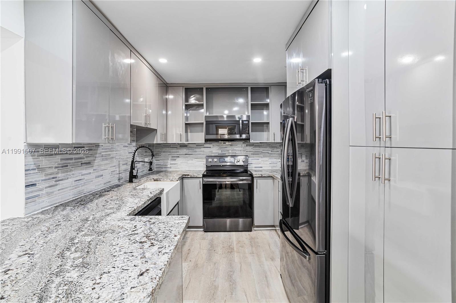 4157 Southwest 49th Court Dania Beach, FL 33314 - Photo 12 of 46 a kitchen with a refrigerator sink and stove