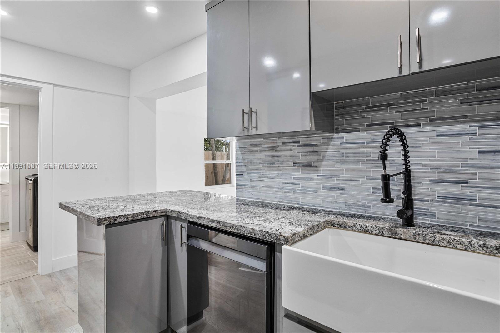 4157 Southwest 49th Court Dania Beach, FL 33314 - Photo 14 of 46 a kitchen with a sink and a refrigerator