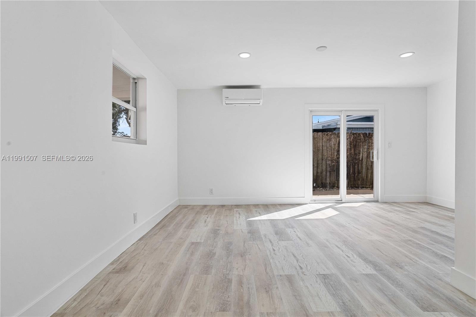 4157 Southwest 49th Court Dania Beach, FL 33314 - Photo 17 of 46 a view of an empty room with wooden floor and a window