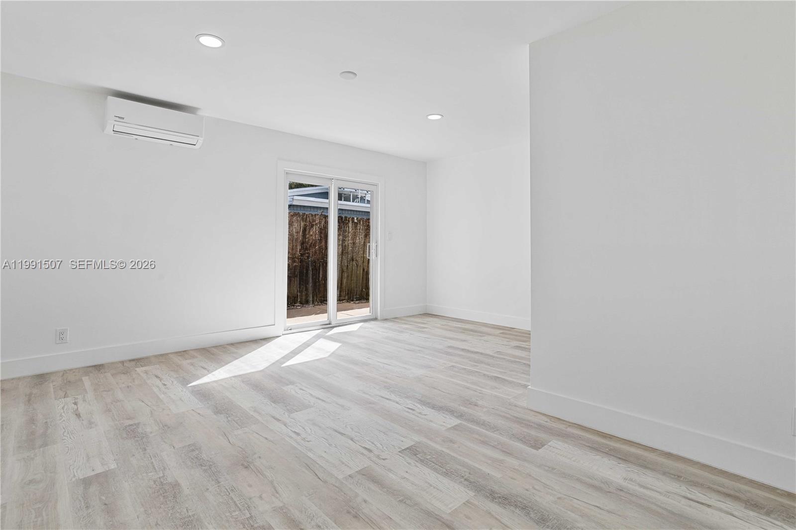 4157 Southwest 49th Court Dania Beach, FL 33314 - Photo 18 of 46 an empty room with wooden floor and windows