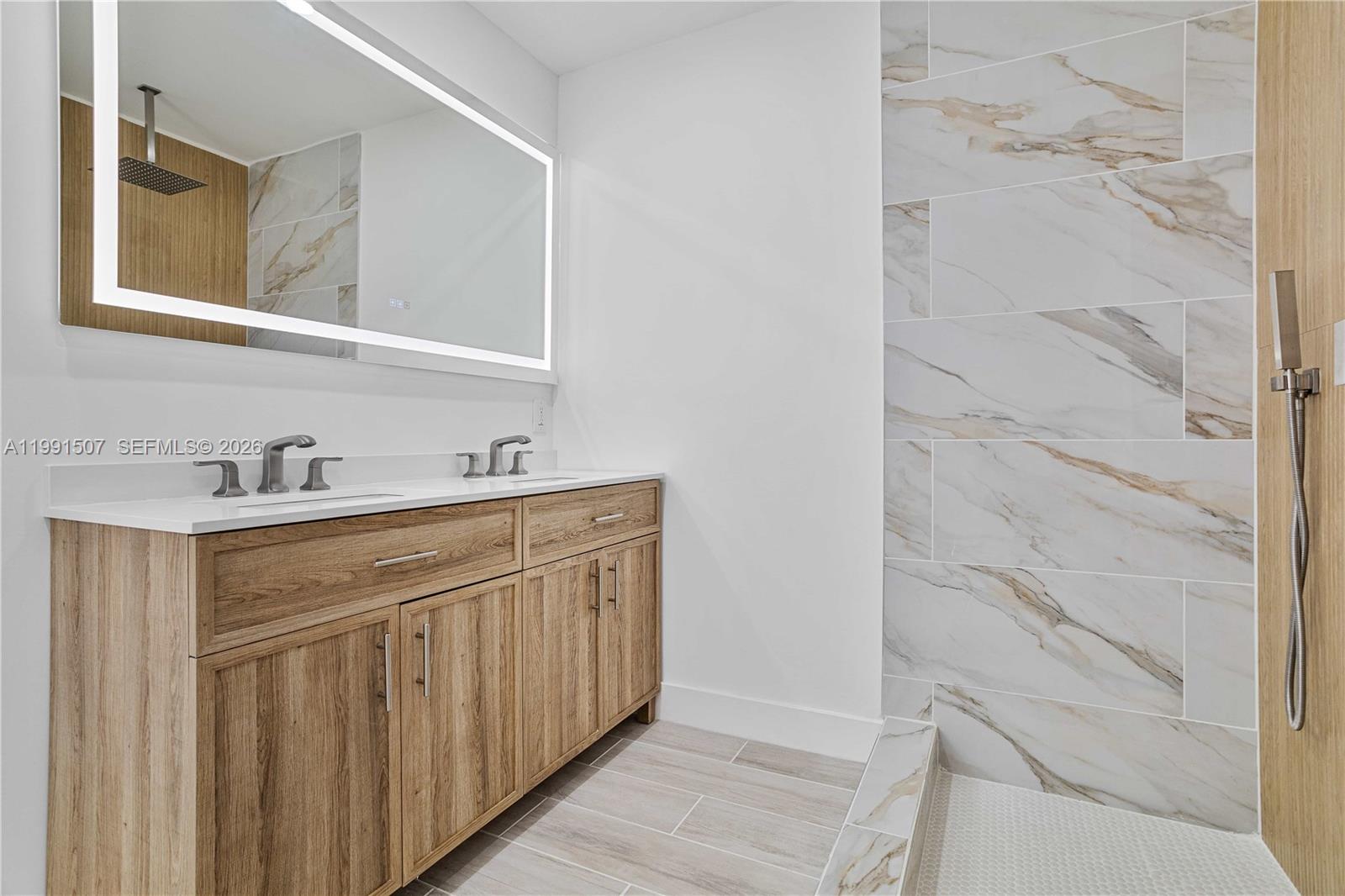 4157 Southwest 49th Court Dania Beach, FL 33314 - Photo 22 of 46 a bathroom with a double vanity sink and mirror